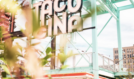 Taco store sign hanging on an irregular structure