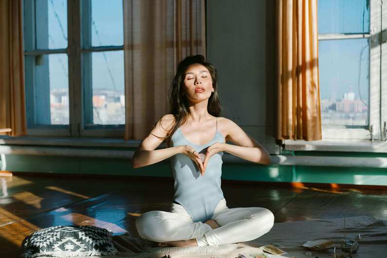 woman meditating while sitting